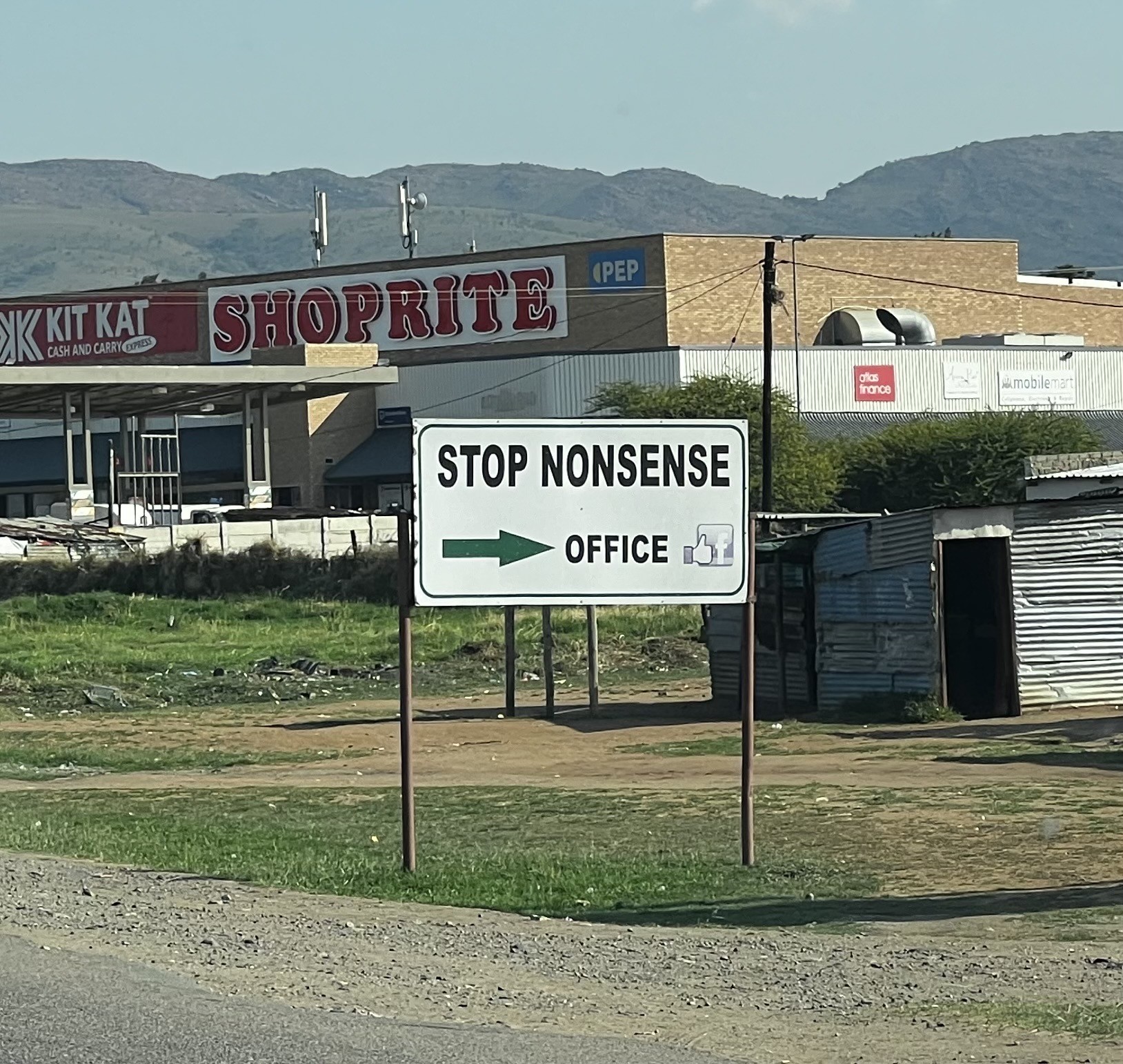 A business road sign that reads: “Stop Nonsense” and an arrow pointing to the office. 