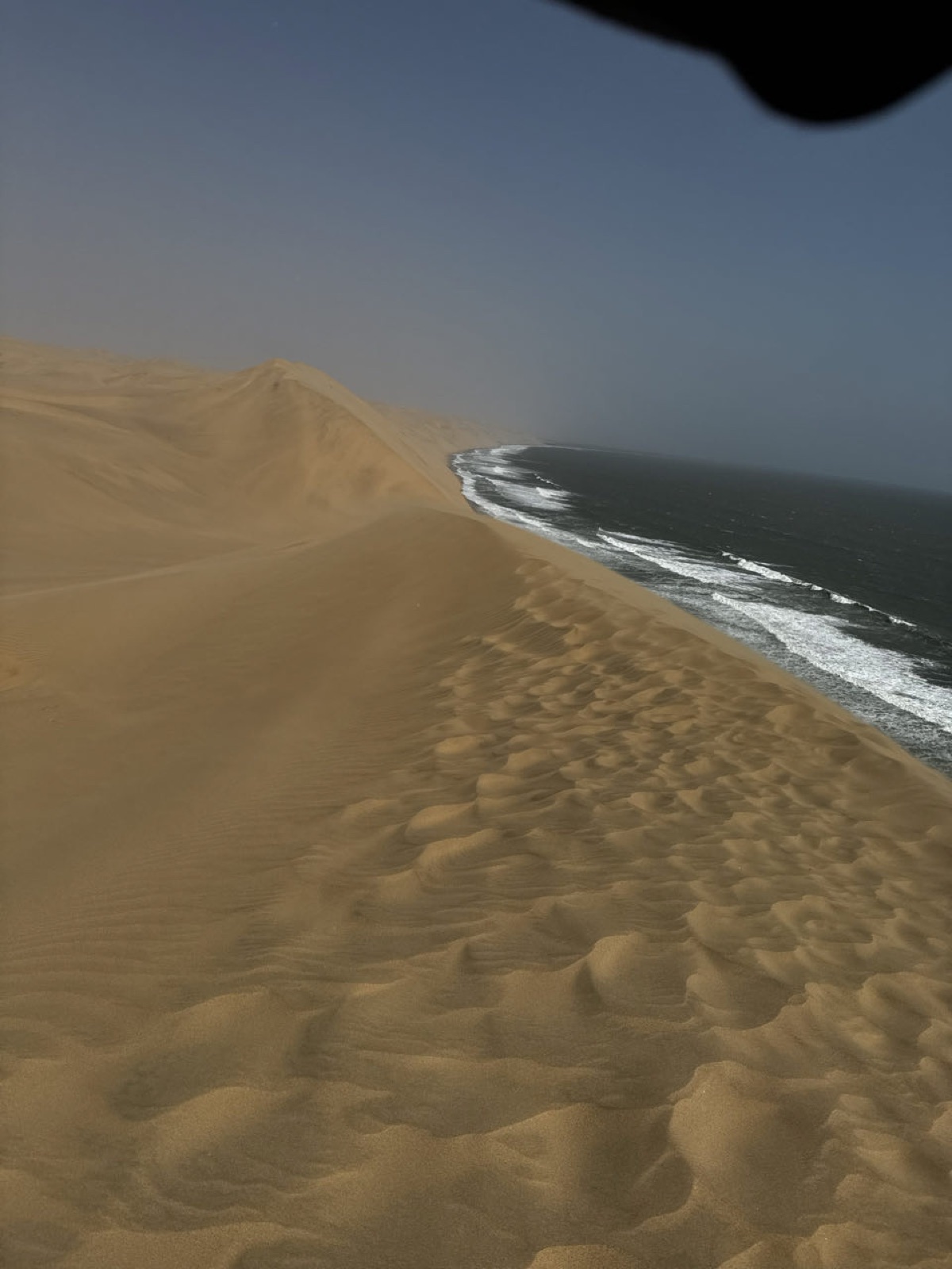 Dunes dropping straight into the Atlantic at Sandwich Harbour